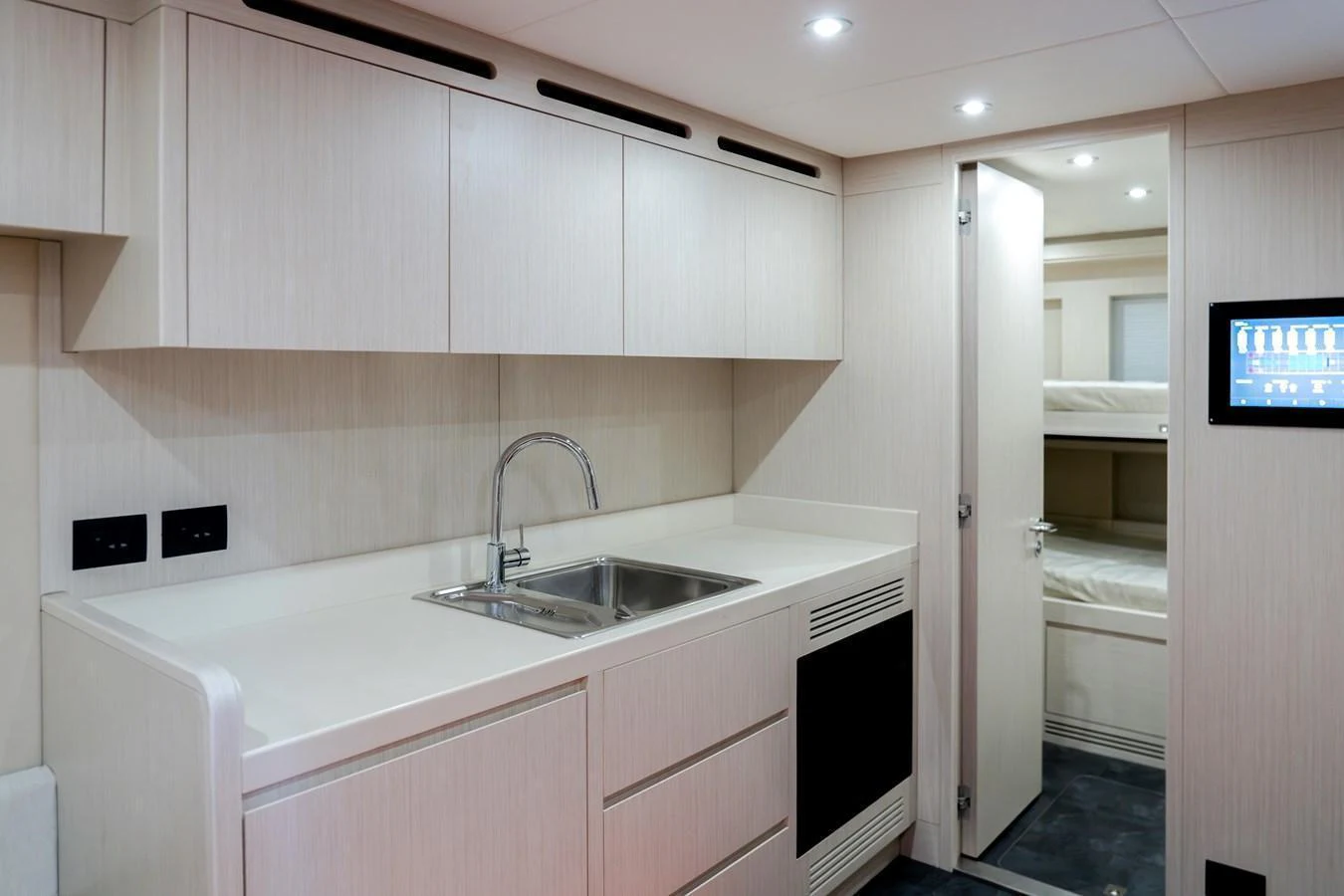 The yacht's galley features modern cabinetry, a sleek sink, and ample counter space. aboard 100 TERRACE ON-ORDER Yacht for Sale