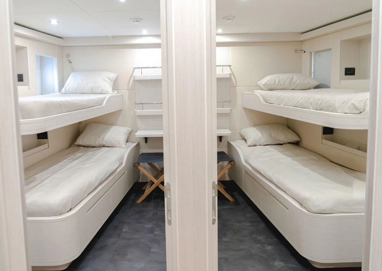 The guest cabin features four cozy bunk beds with a minimalist design and ample storage space. aboard 100 TERRACE ON-ORDER Yacht for Sale