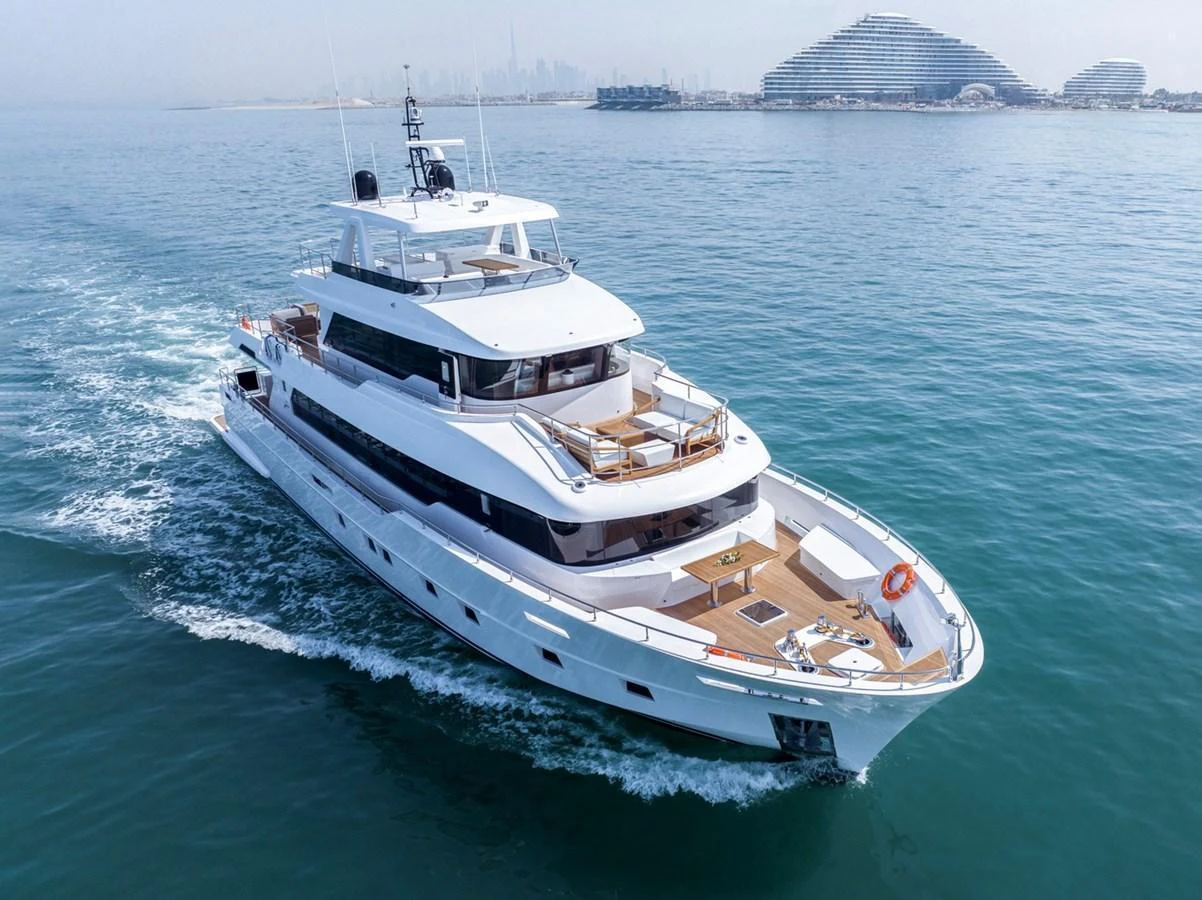 A sleek and modern yacht cruises gracefully on calm waters, showcasing its luxurious design and spacious decks. aboard NOMAD 101 ON-ORDER Yacht for Sale