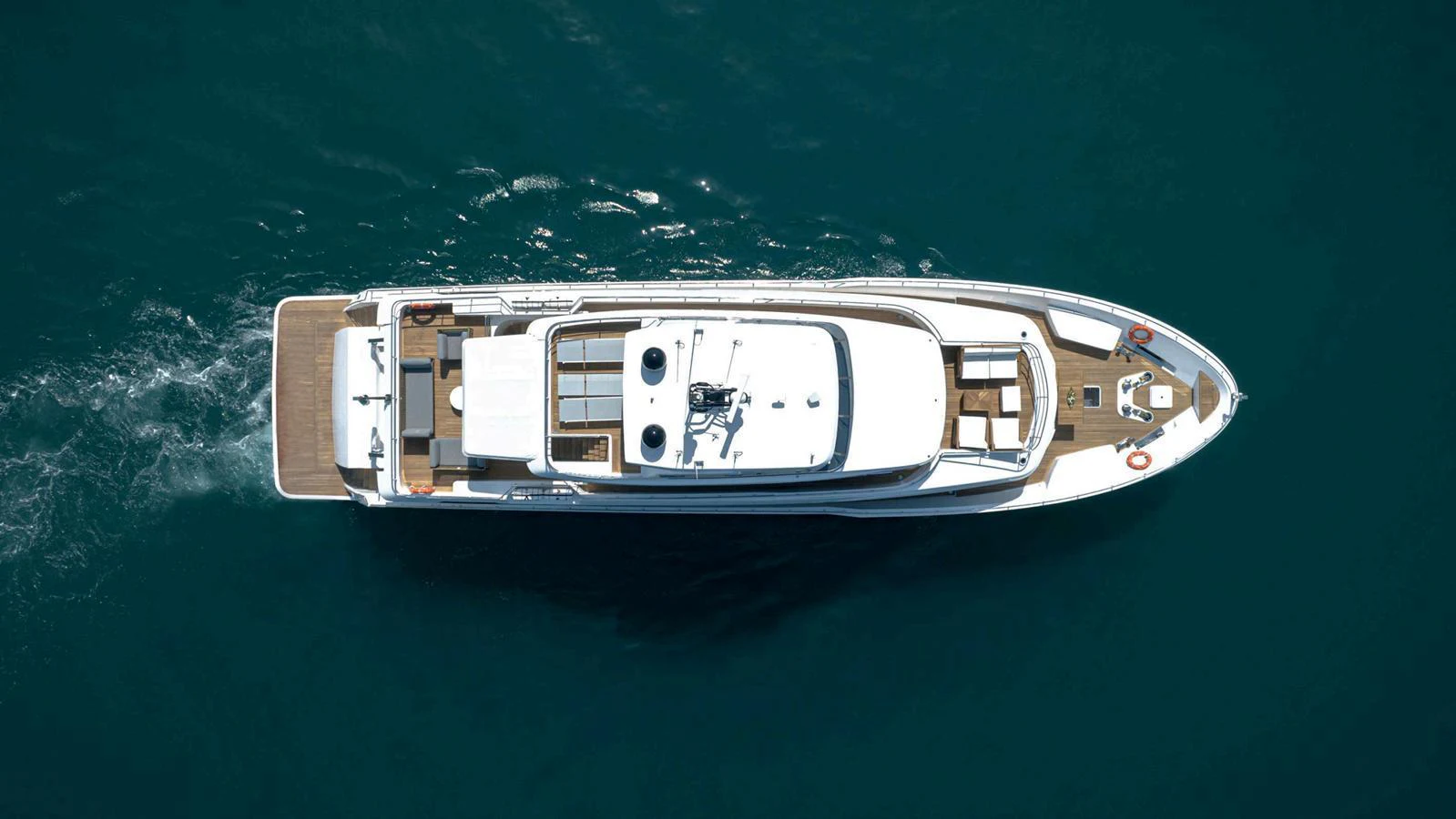 An aerial view of a sleek yacht cruising through the water. aboard NOMAD 101 ON-ORDER Yacht for Sale