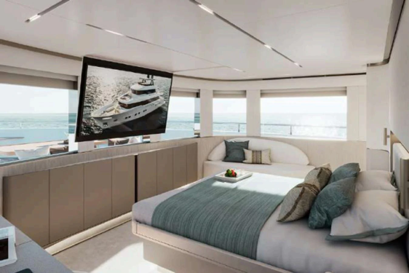 A luxurious stateroom featuring a large bed and a flat-screen TV with a view of the sea. aboard NOMAD 101 ON-ORDER Yacht for Sale