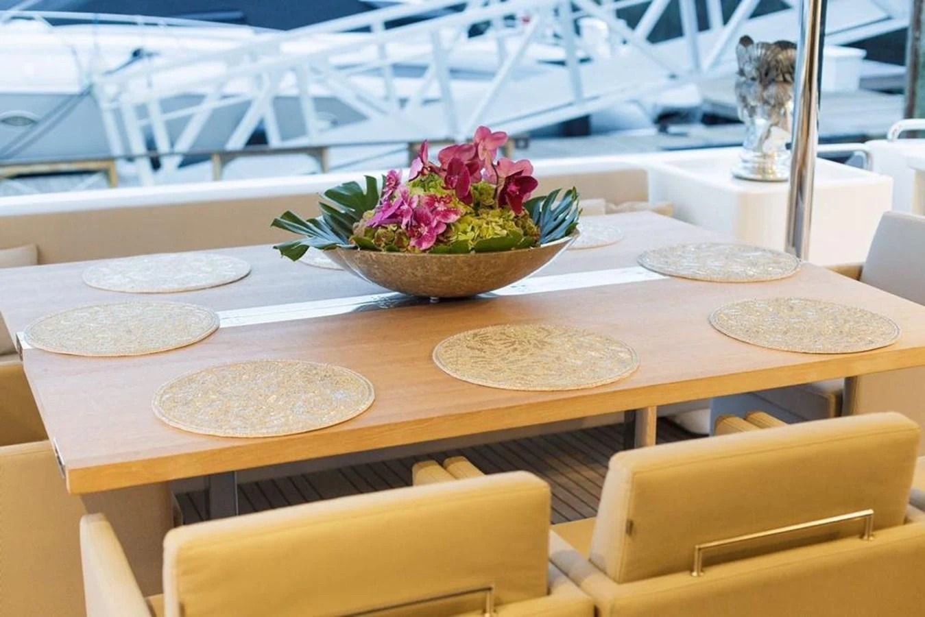 The yacht features an elegant dining area with a beautifully set table and floral centerpiece. aboard SHA SHA SHA IV Yacht for Sale