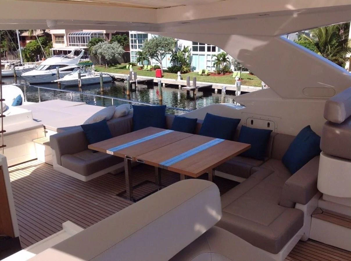 The aft deck features a spacious seating area with a large table, perfect for outdoor dining and relaxation. aboard SHA SHA SHA IV Yacht for Sale