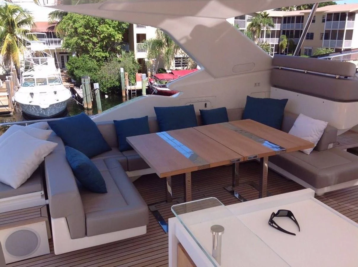 The aft deck features a comfortable seating area with a wooden table, perfect for outdoor relaxation. aboard SHA SHA SHA IV Yacht for Sale