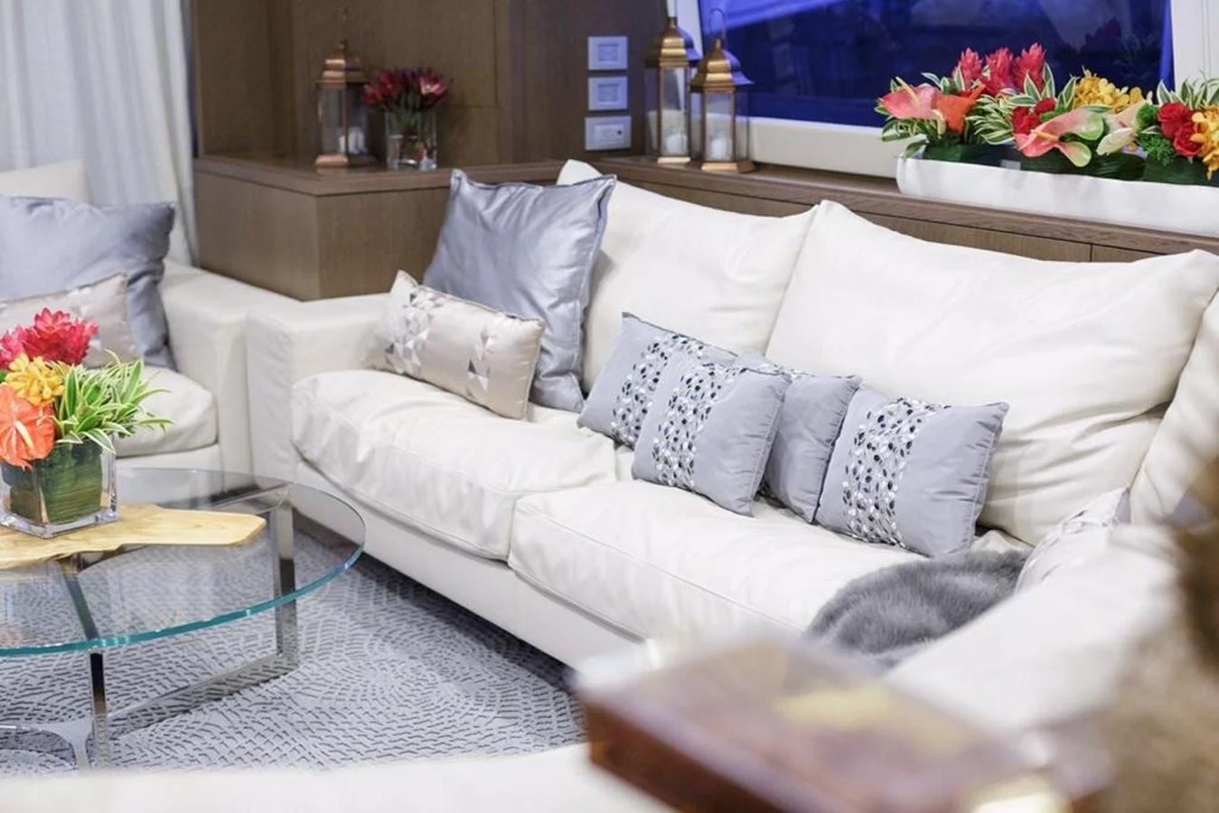 The salon features plush white sofas adorned with decorative pillows, creating a cozy and inviting atmosphere. aboard SHA SHA SHA IV Yacht for Sale