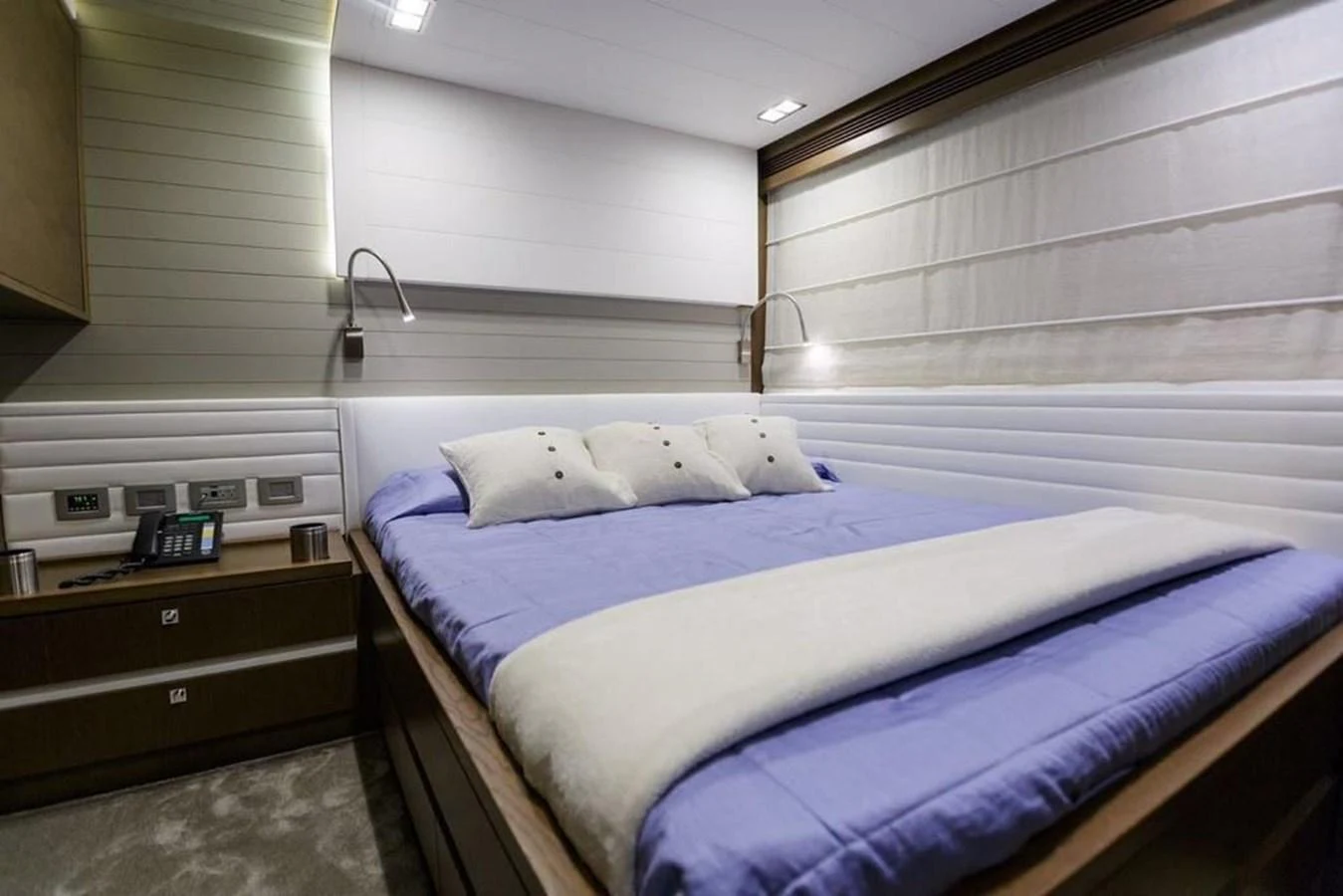 The stateroom features a plush bed with modern lighting and ample storage. aboard SHA SHA SHA IV Yacht for Sale
