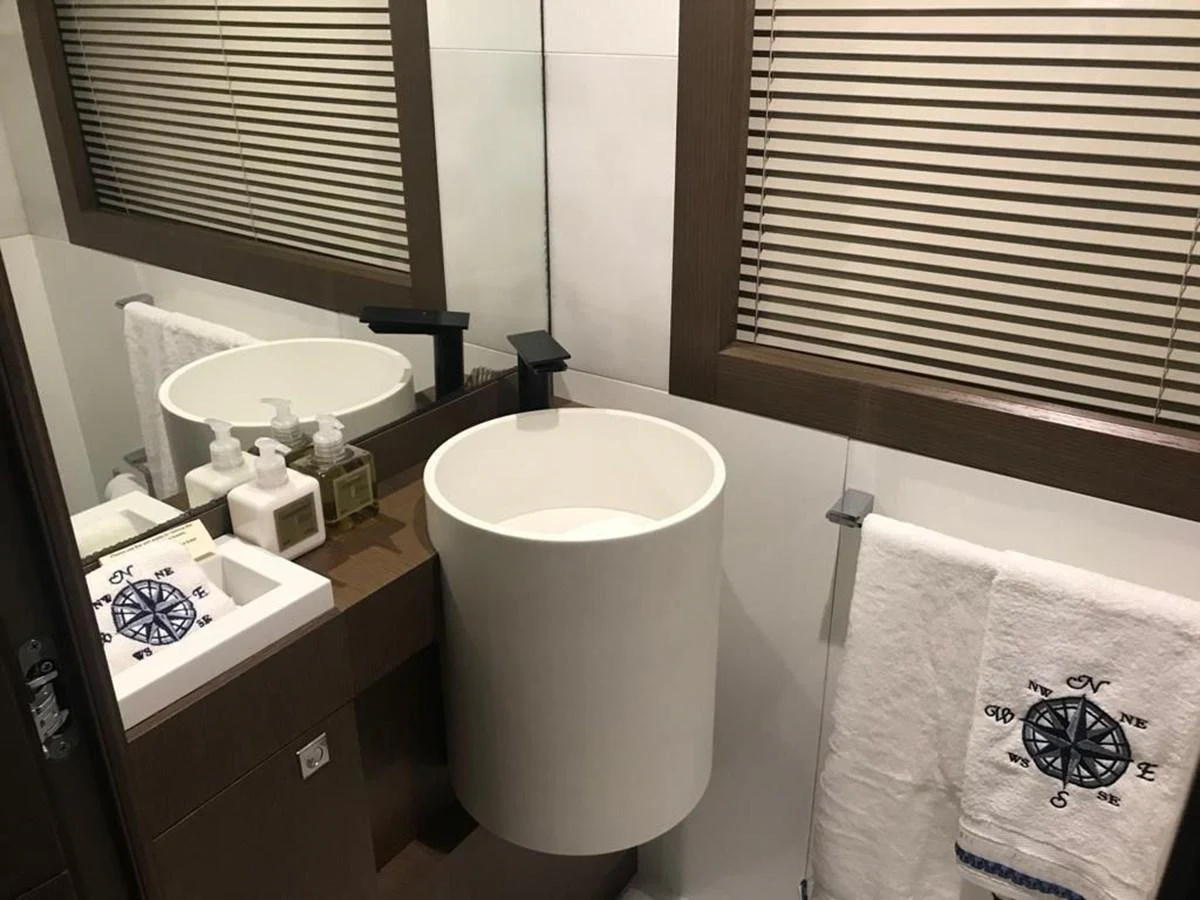 The yacht's bathroom features modern fixtures and a nautical-themed decor. aboard SHA SHA SHA IV Yacht for Sale