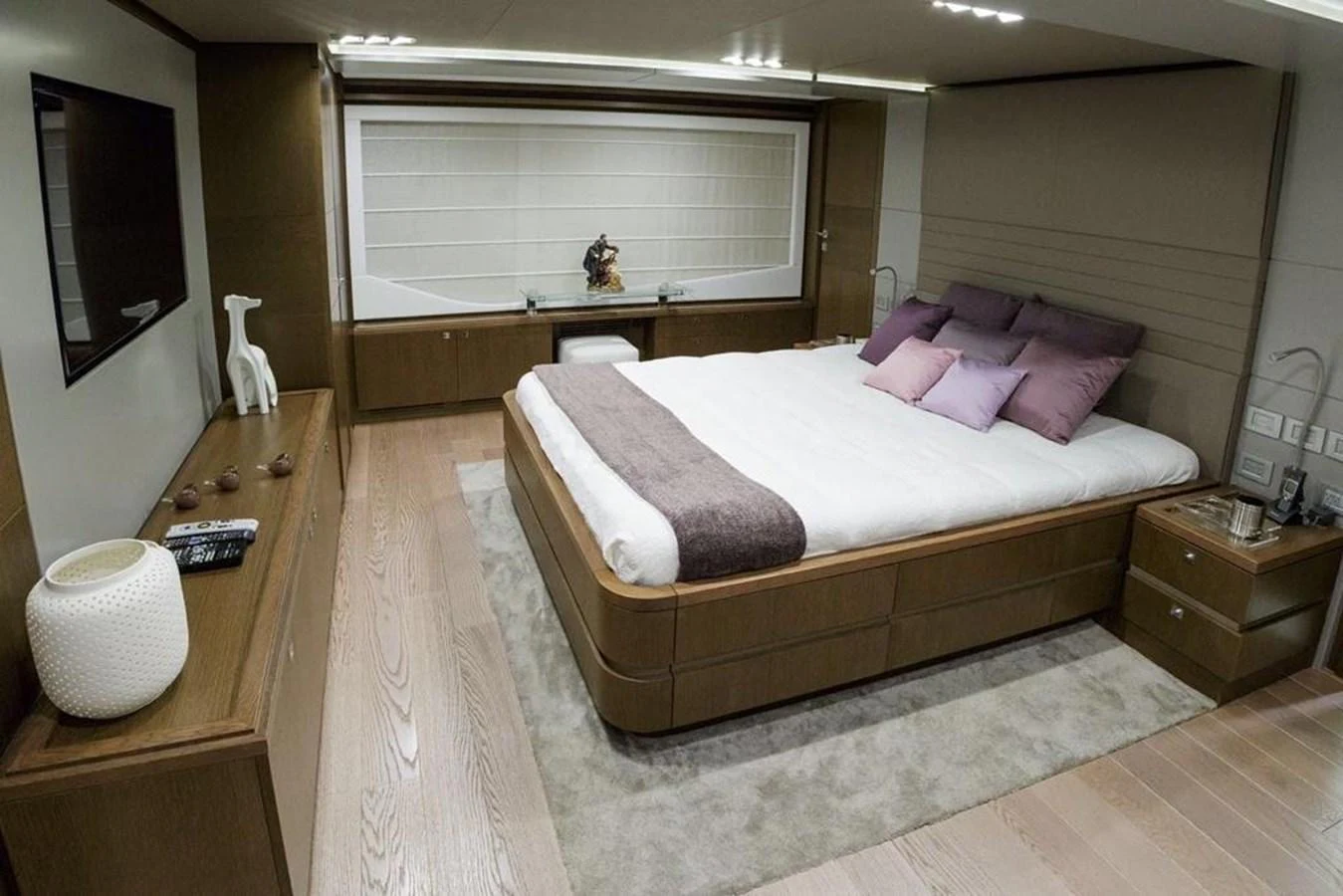 The master stateroom features a luxurious bed with plush pillows and modern decor. aboard SHA SHA SHA IV Yacht for Sale