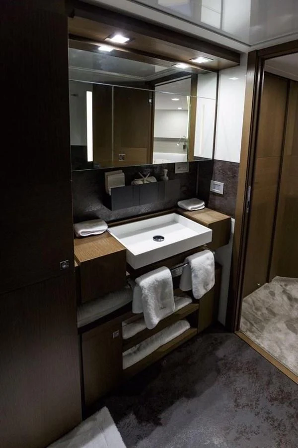 A luxurious yacht bathroom featuring a modern sink and ample storage space. aboard SHA SHA SHA IV Yacht for Sale