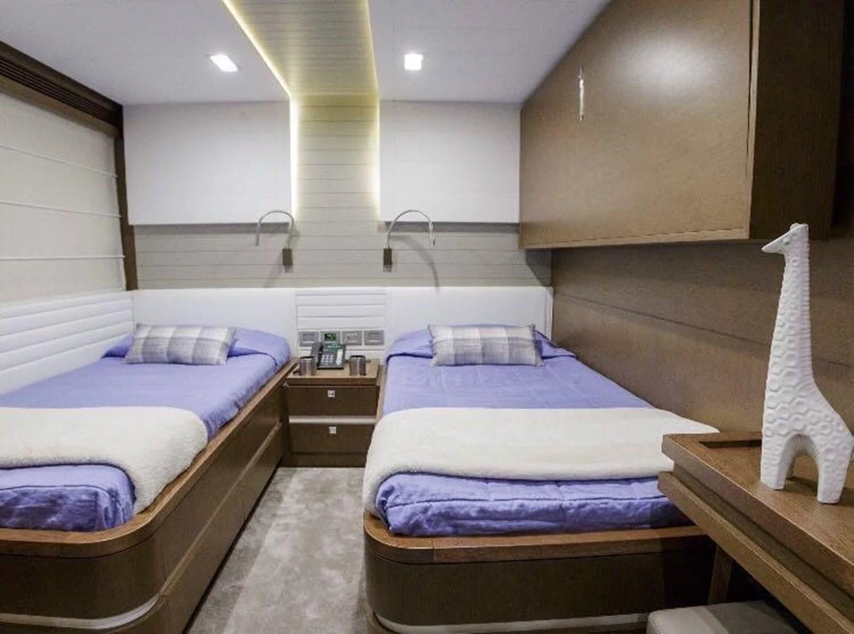 The twin stateroom features two comfortable beds with modern decor and ample lighting. aboard SHA SHA SHA IV Yacht for Sale