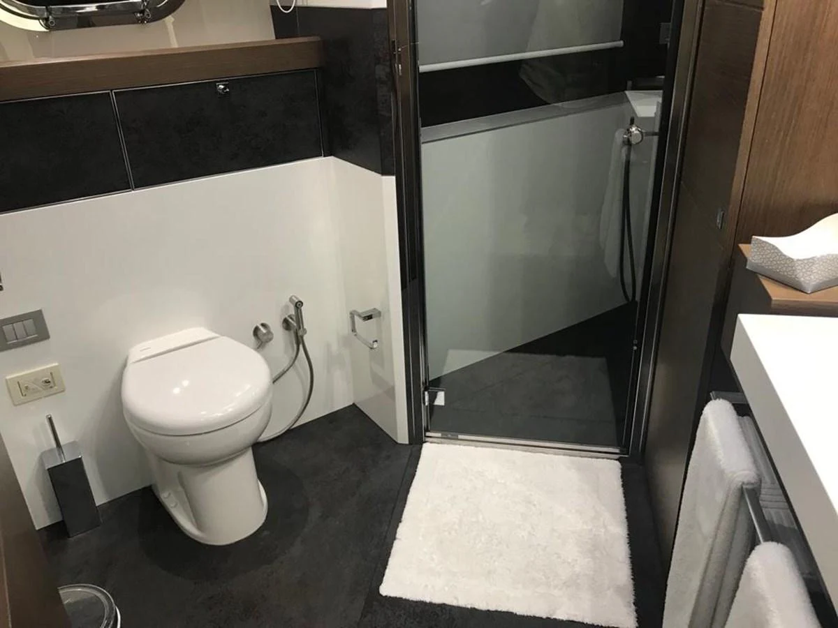 A modern yacht bathroom with sleek fixtures and a clean design. aboard SHA SHA SHA IV Yacht for Sale