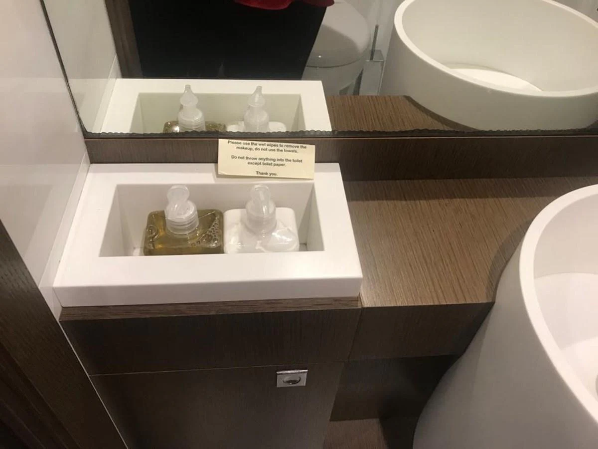 A close-up of a bathroom vanity with soap and lotion dispensers. aboard SHA SHA SHA IV Yacht for Sale