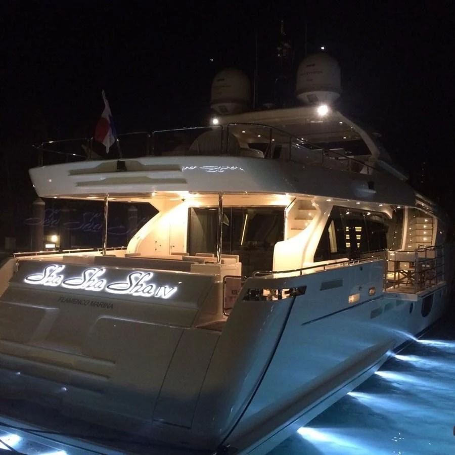 The yacht's illuminated aft deck glows beautifully against the night sky, showcasing its elegance and sophistication. aboard SHA SHA SHA IV Yacht for Sale