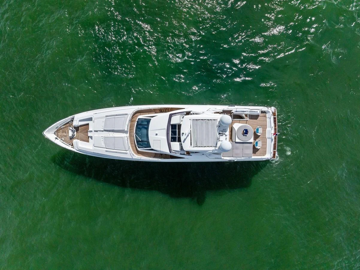 An aerial view of a sleek yacht cruising through green waters. aboard SHA SHA SHA IV Yacht for Sale