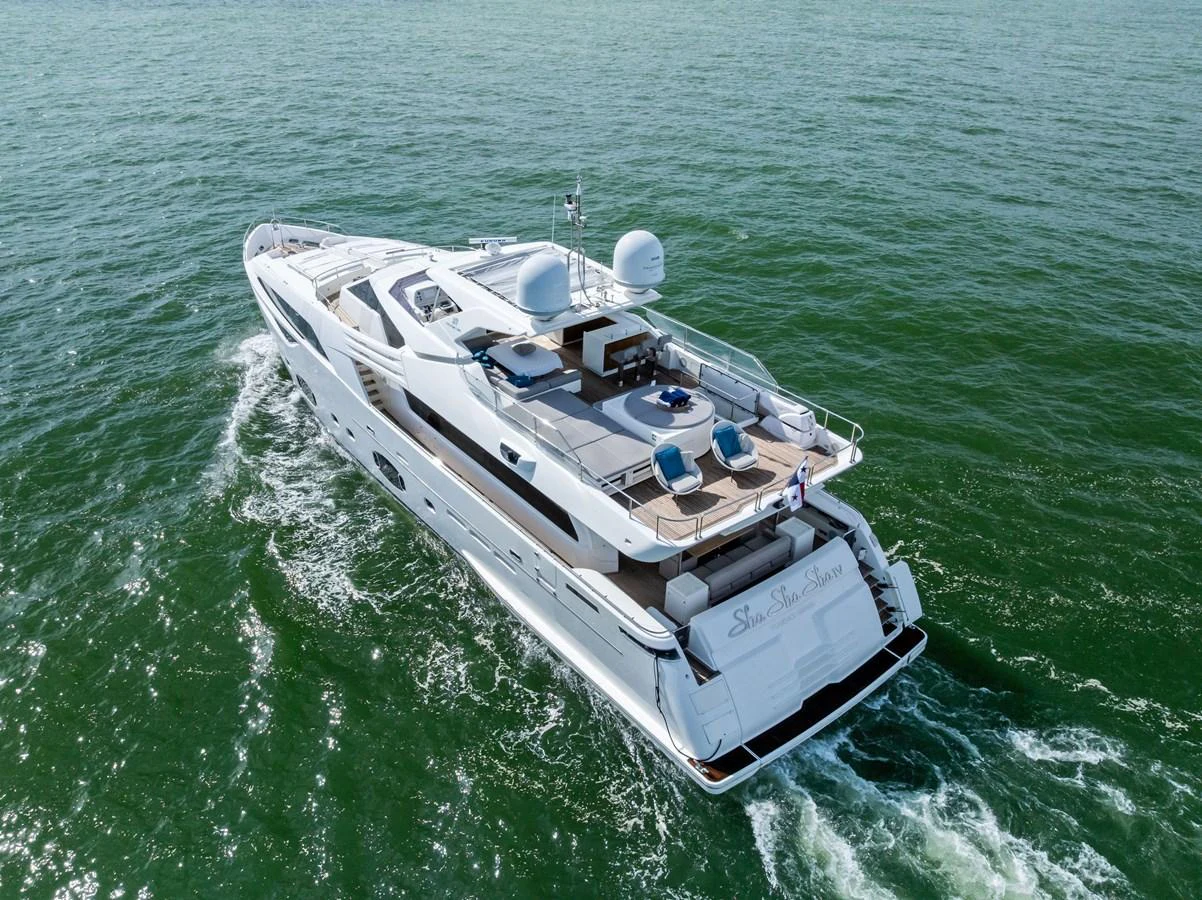 A luxurious yacht cruising on calm waters, showcasing its sleek design and spacious deck. aboard SHA SHA SHA IV Yacht for Sale