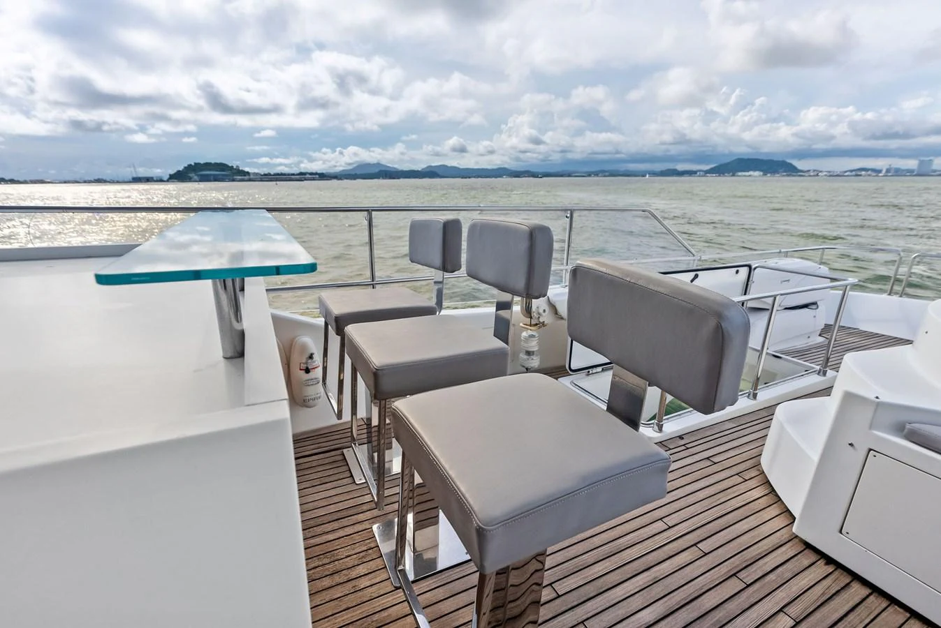 The flybridge offers a stylish bar area with modern seating and panoramic views. aboard SHA SHA SHA IV Yacht for Sale