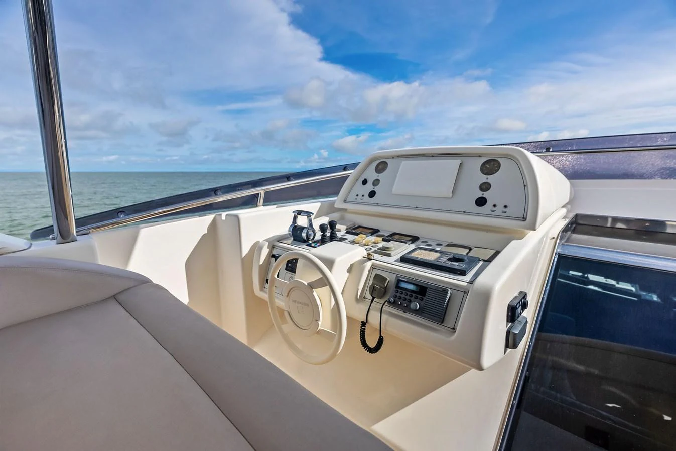 The helm station offers a commanding view with modern navigation equipment and comfortable seating. aboard SHA SHA SHA IV Yacht for Sale
