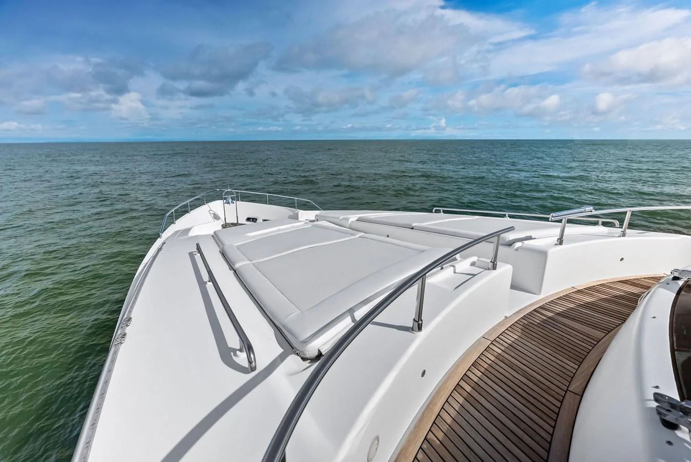 The foredeck offers a spacious sunbathing area with comfortable cushions, perfect for enjoying the open sea views. aboard SHA SHA SHA IV Yacht for Sale