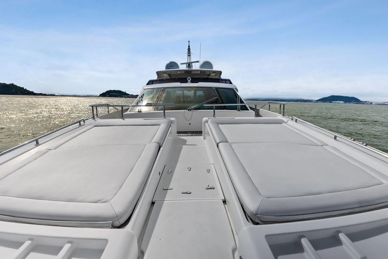 The yacht's foredeck features spacious sun pads for relaxation with a stunning view of the water. aboard SHA SHA SHA IV Yacht for Sale