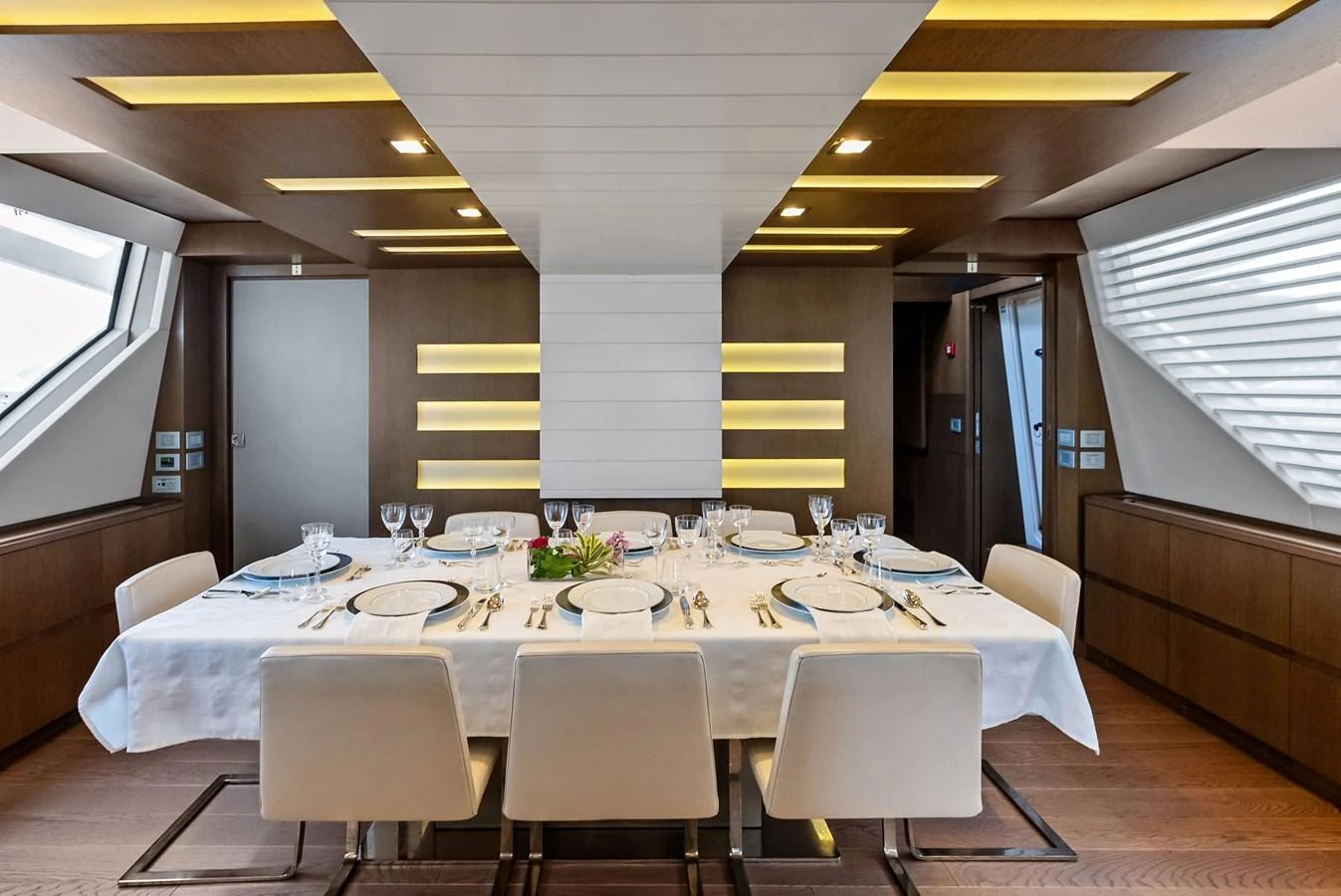 The yacht's dining area features a modern and elegant setting with a large table and comfortable seating. aboard SHA SHA SHA IV Yacht for Sale