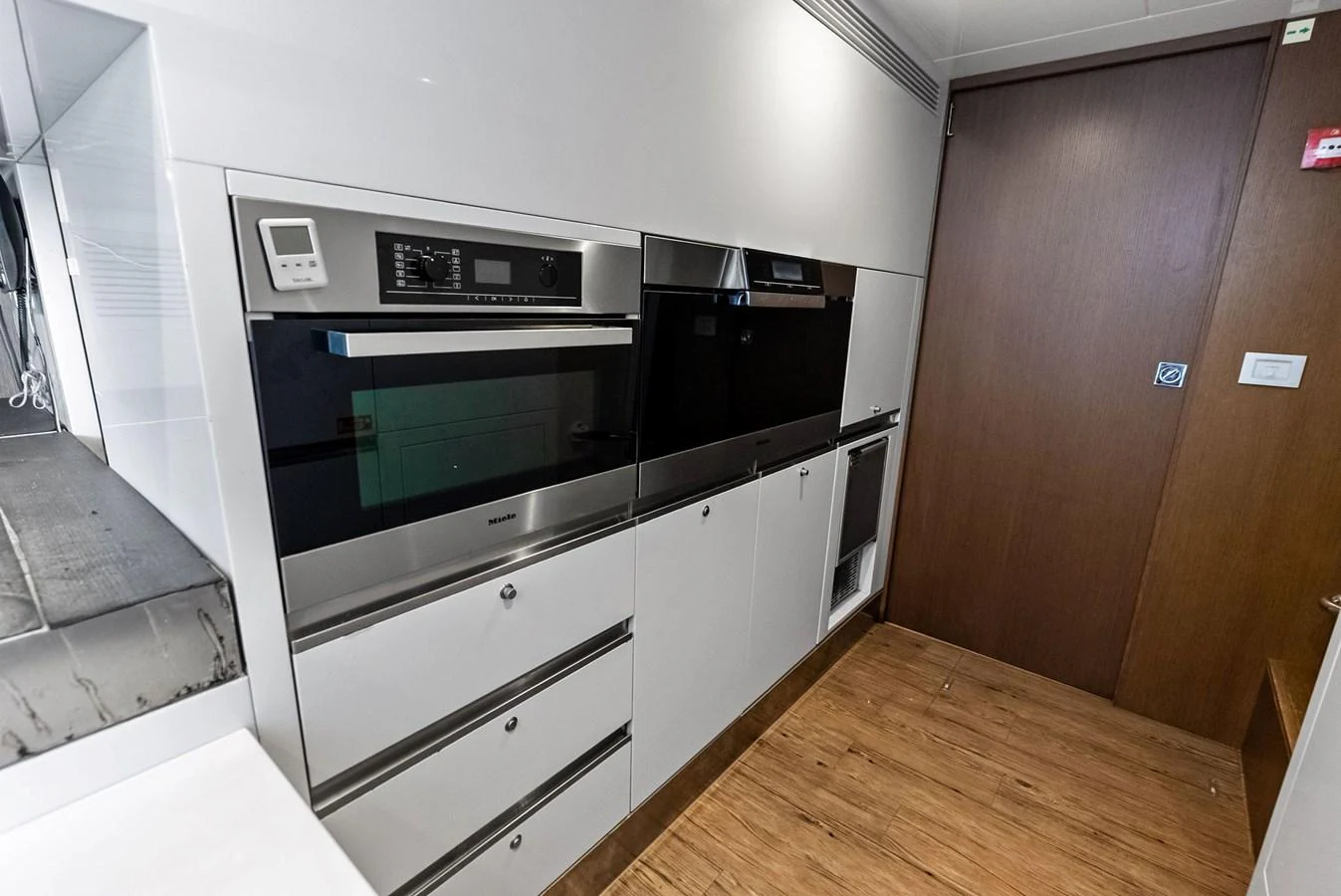 The galley features modern appliances and sleek cabinetry, perfect for gourmet cooking at sea. aboard SHA SHA SHA IV Yacht for Sale