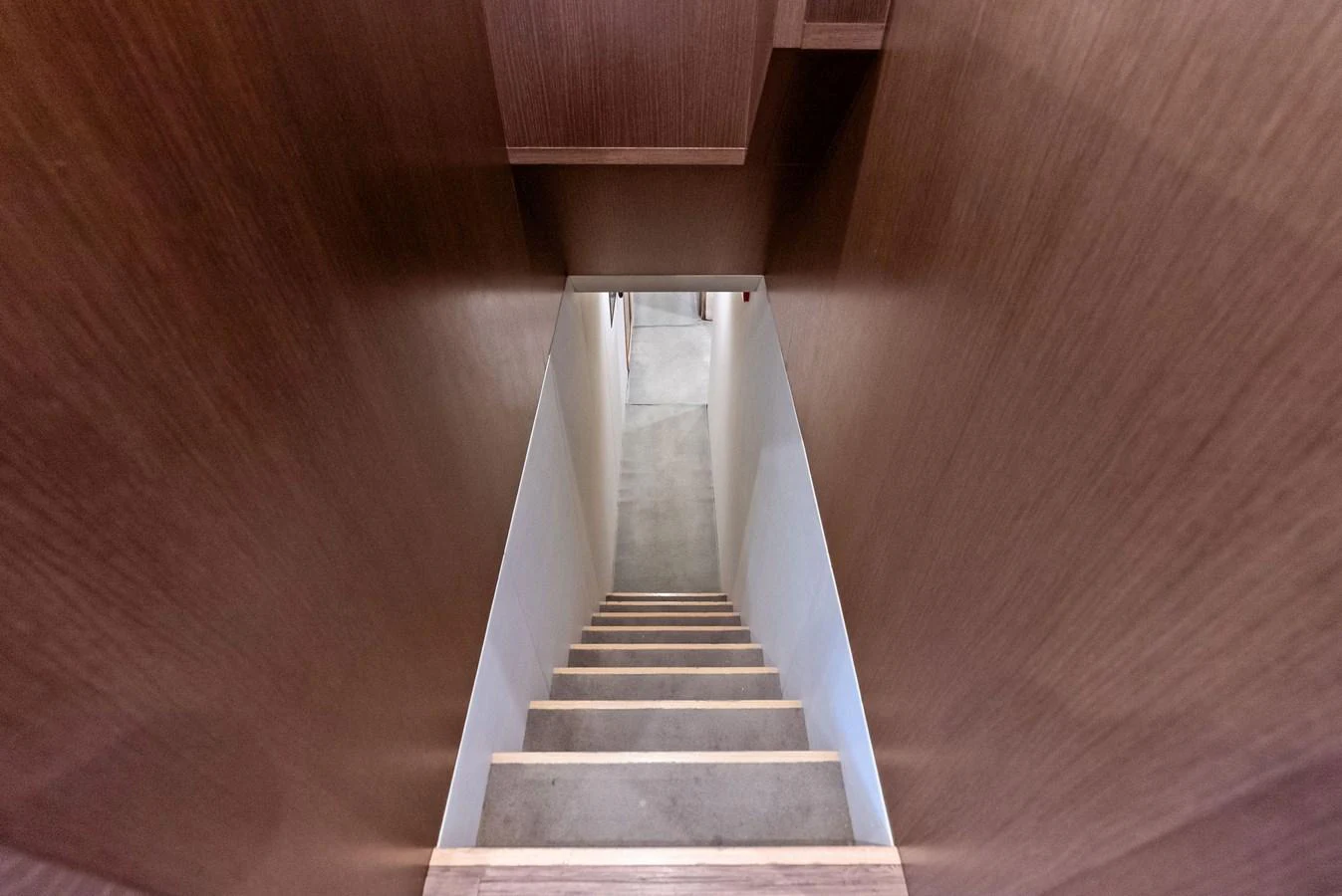 A sleek wooden staircase leads down to the lower deck of the yacht. aboard SHA SHA SHA IV Yacht for Sale