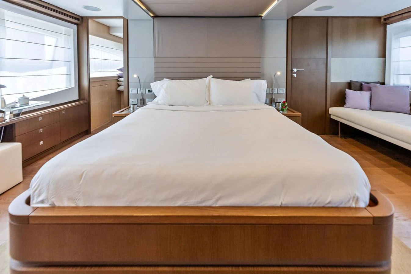 The master stateroom features a spacious bed with elegant wood finishes and ample natural light. aboard SHA SHA SHA IV Yacht for Sale