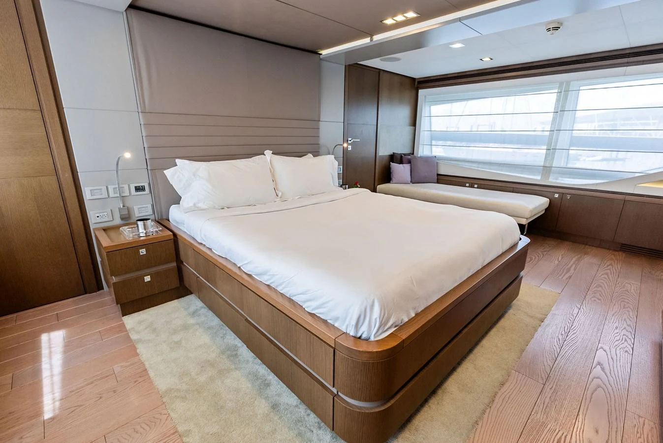 The master stateroom offers a spacious and serene retreat with modern furnishings and large windows. aboard SHA SHA SHA IV Yacht for Sale