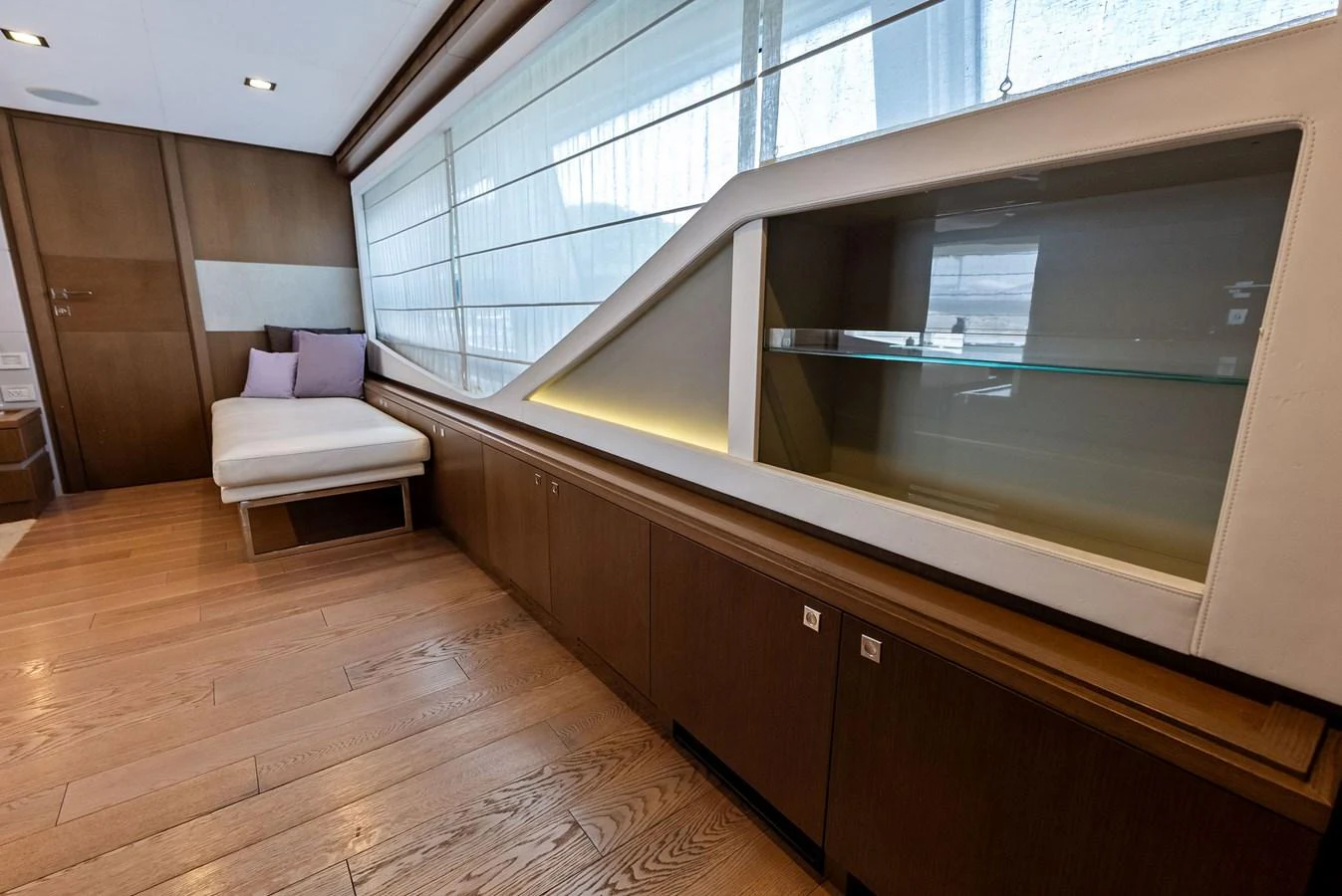 The yacht's interior features a sleek, modern design with wooden flooring and ample natural light. aboard SHA SHA SHA IV Yacht for Sale