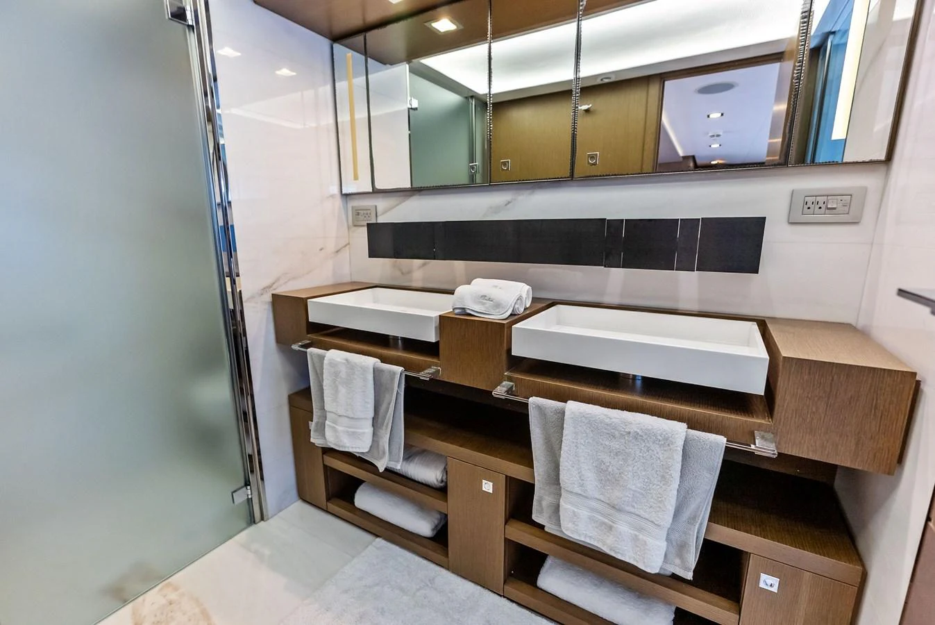 The yacht's bathroom features modern fixtures and ample storage space. aboard SHA SHA SHA IV Yacht for Sale