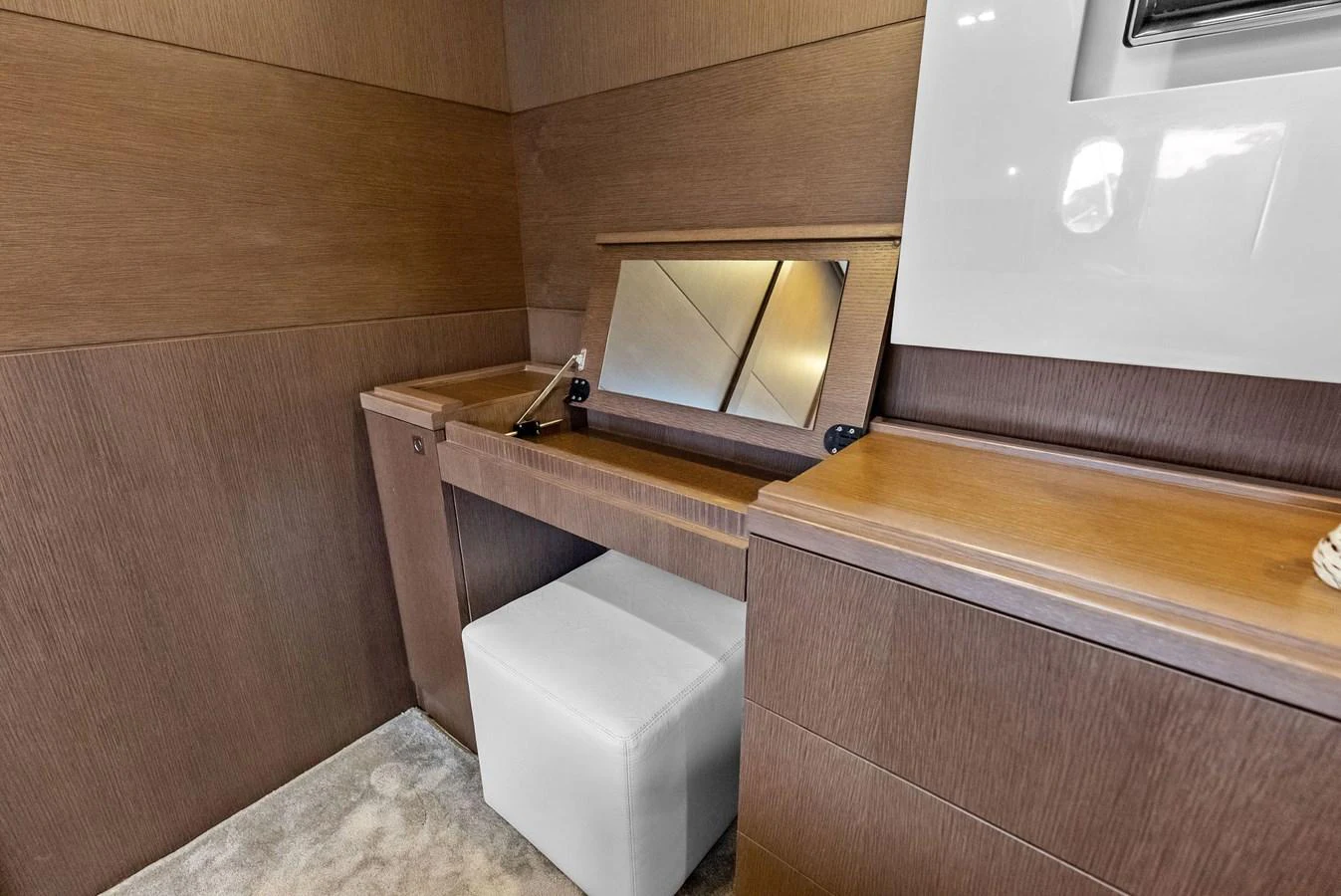 The image showcases a sleek and modern vanity area within the yacht's interior. aboard SHA SHA SHA IV Yacht for Sale