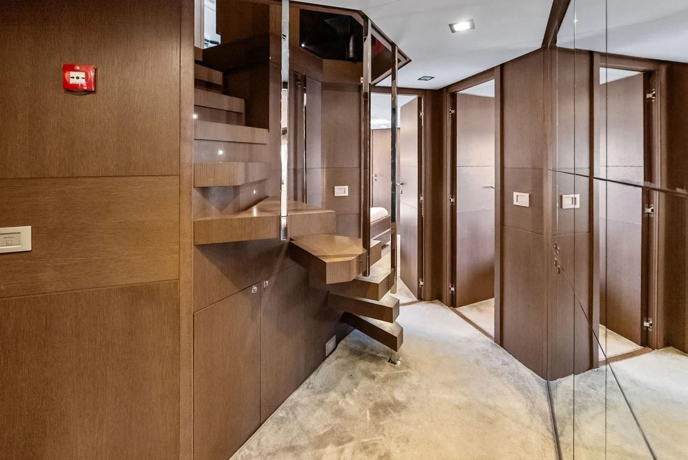 This image showcases a modern staircase within the yacht's interior, featuring sleek wooden finishes and contemporary design. aboard SHA SHA SHA IV Yacht for Sale