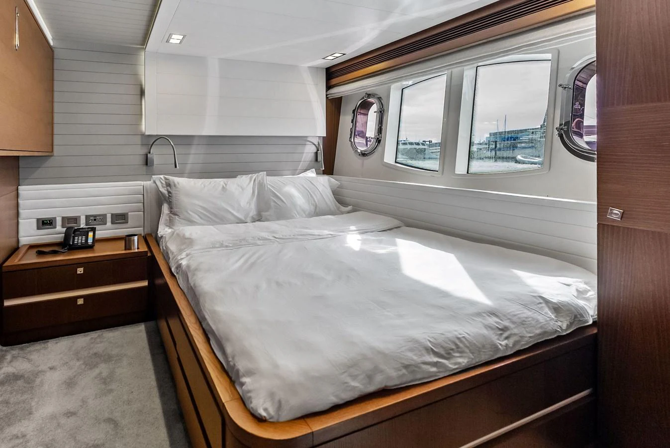 The stateroom features a comfortable bed with ample natural light from the windows. aboard SHA SHA SHA IV Yacht for Sale