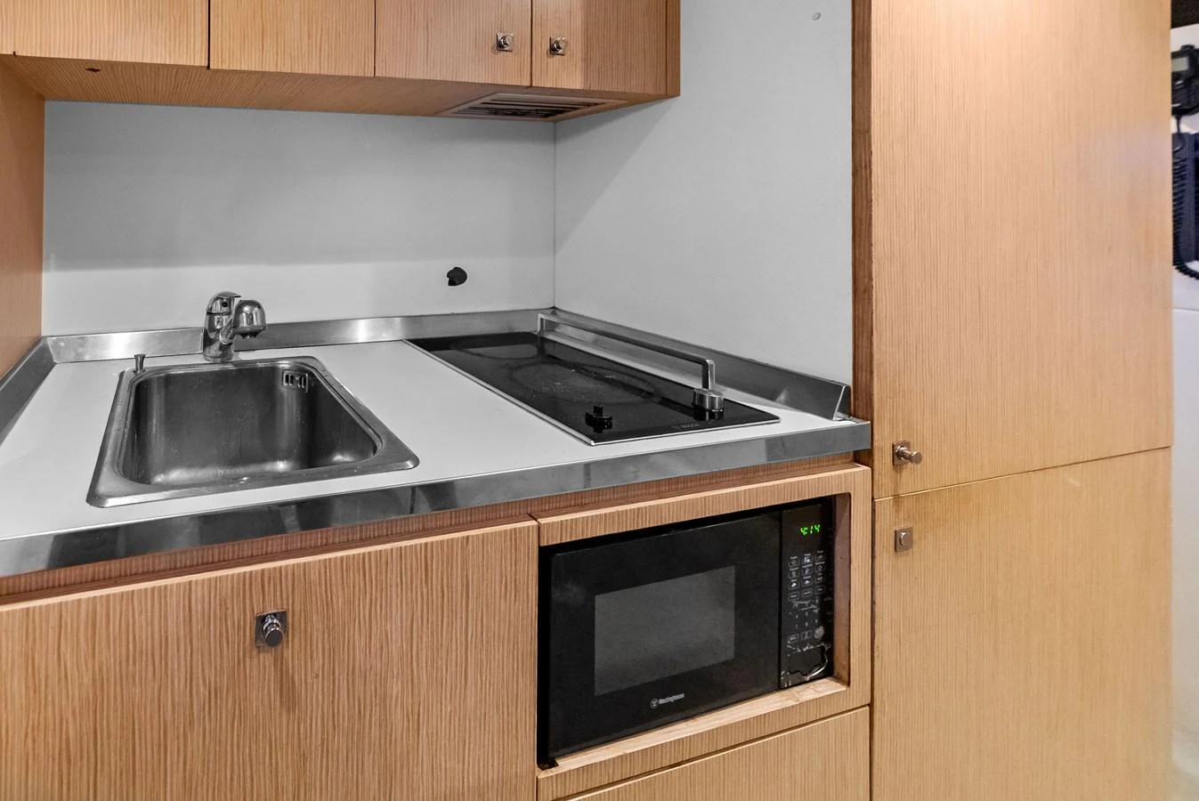 The compact galley features modern appliances and efficient use of space. aboard SHA SHA SHA IV Yacht for Sale