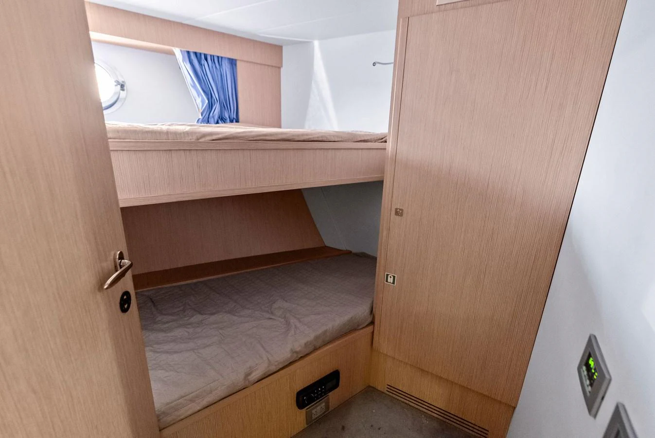 The cozy bunk cabin features two neatly arranged beds with light wood paneling and a small porthole for natural light. aboard SHA SHA SHA IV Yacht for Sale