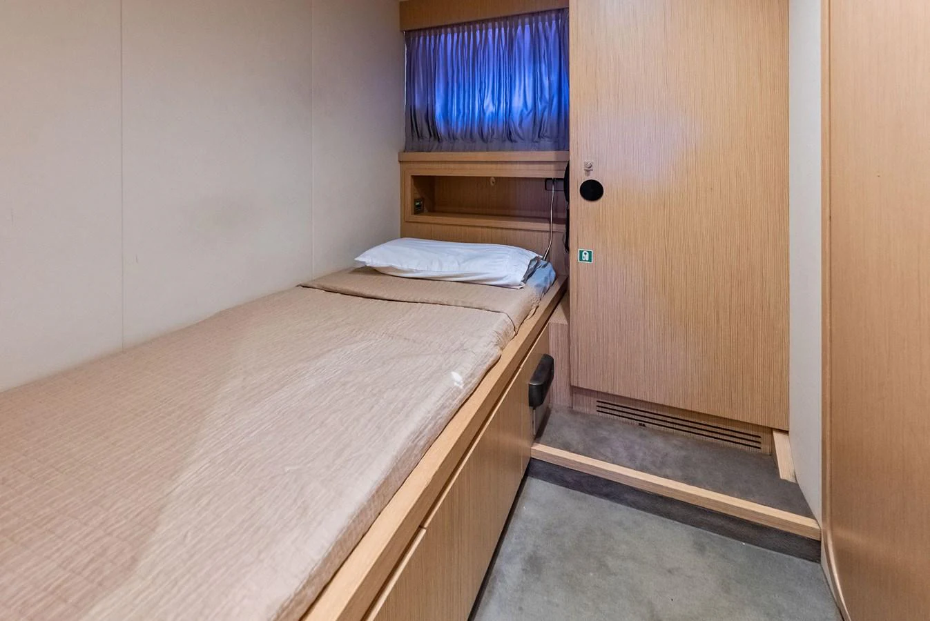 A cozy single cabin with a minimalist design and warm wooden tones. aboard SHA SHA SHA IV Yacht for Sale