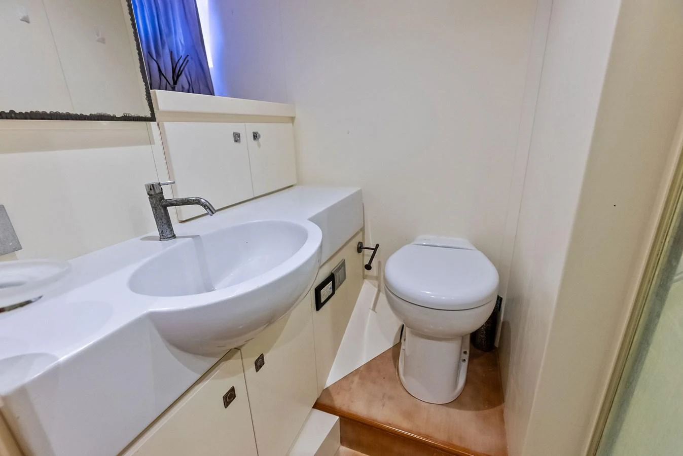 The yacht's bathroom features a sleek sink and modern fixtures. aboard SHA SHA SHA IV Yacht for Sale