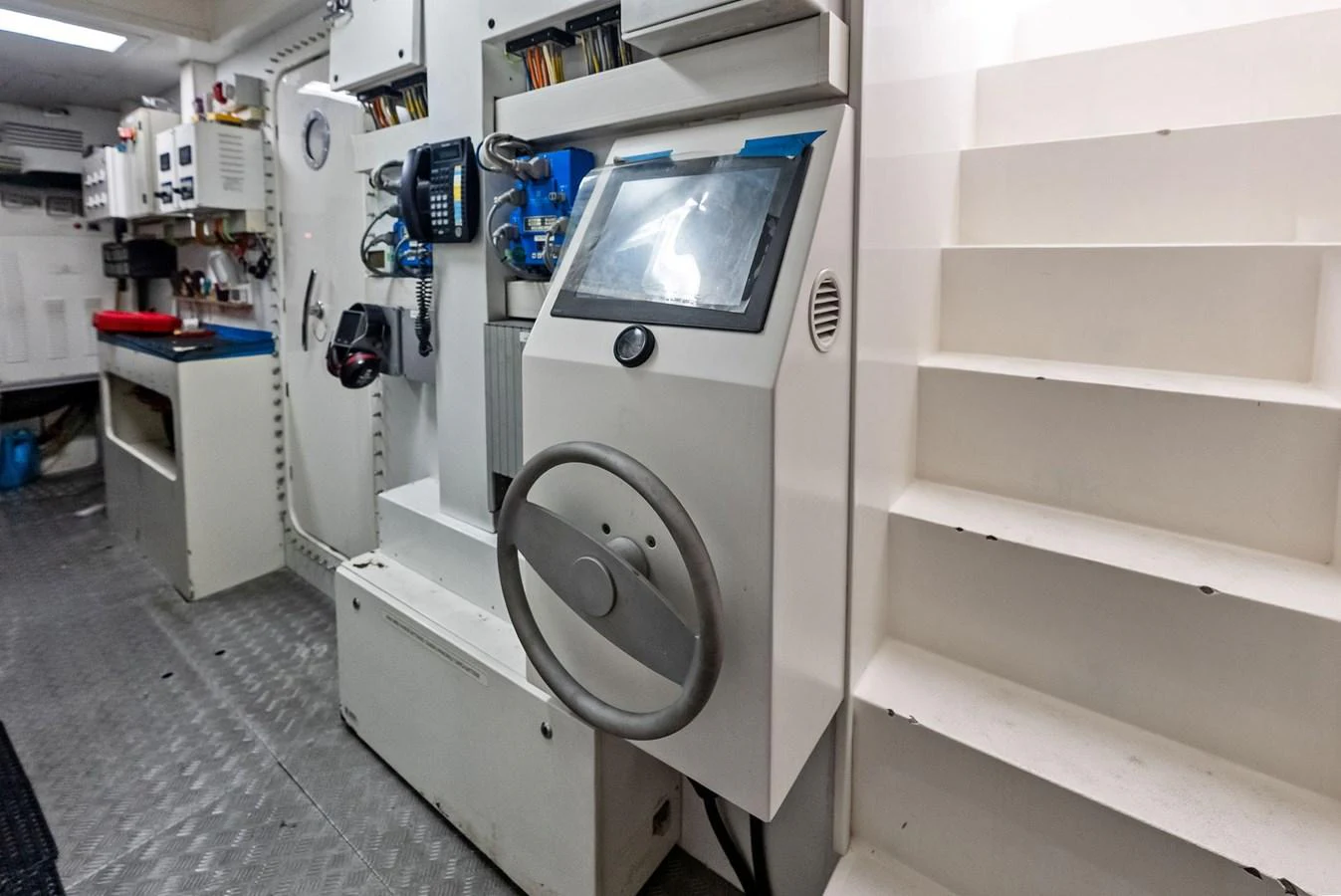 The image showcases a technical area within the yacht, featuring various control panels and equipment. aboard SHA SHA SHA IV Yacht for Sale