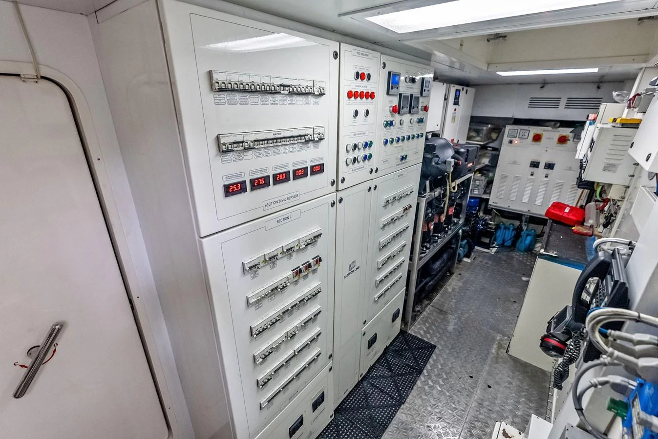 The image showcases the yacht's well-organized and advanced engine room with control panels and equipment. aboard SHA SHA SHA IV Yacht for Sale