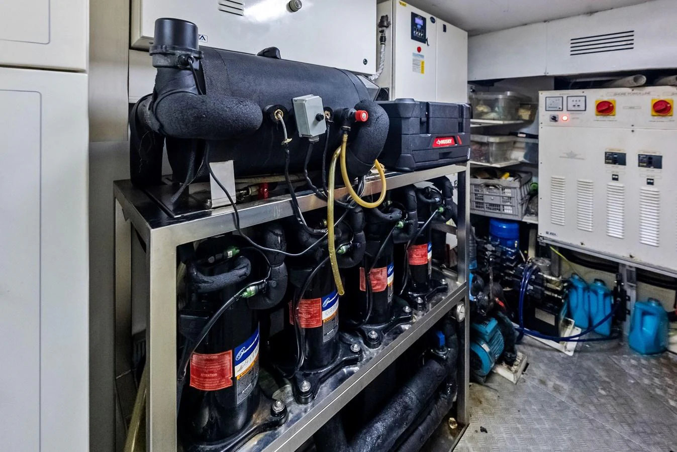 The image showcases the technical equipment and machinery in the yacht's engine room. aboard SHA SHA SHA IV Yacht for Sale