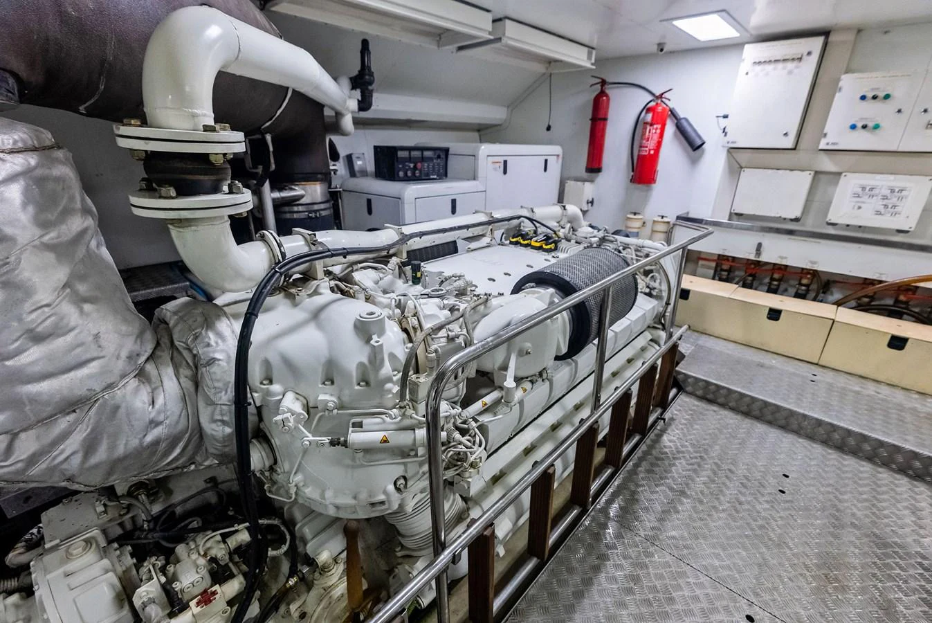 The image showcases the yacht's well-maintained engine room with visible machinery and safety equipment. aboard SHA SHA SHA IV Yacht for Sale