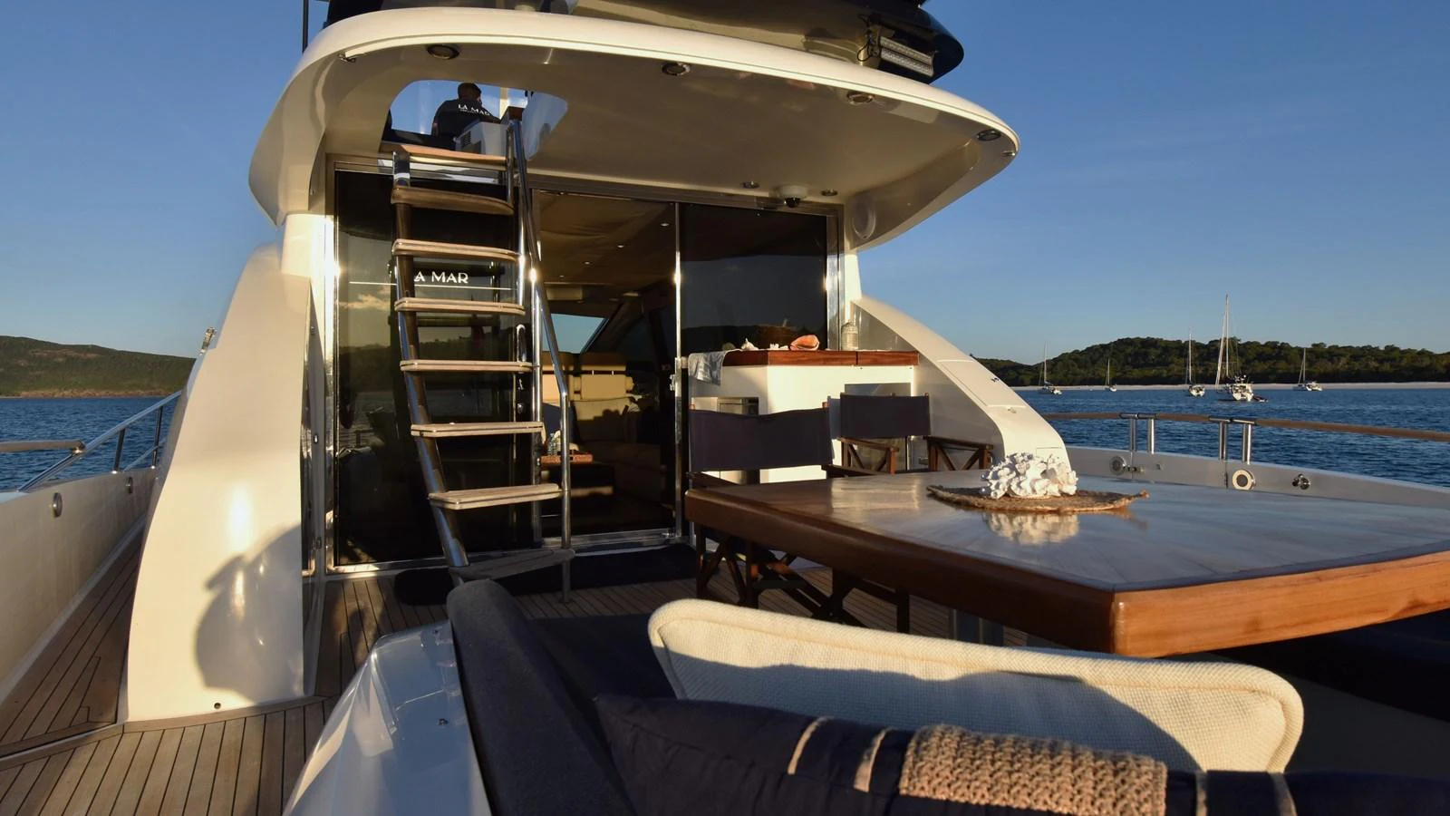 The aft deck offers a luxurious outdoor dining area with stunning views of the surrounding waters. aboard LA MAR Yacht for Sale