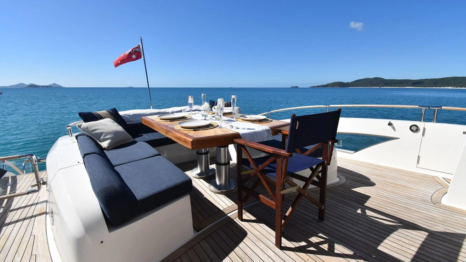 The aft deck features a stylish dining area with a beautiful ocean view. aboard LA MAR Yacht for Sale