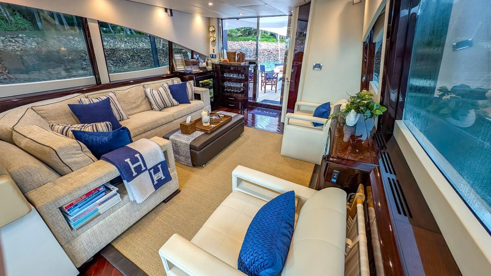 The yacht's salon offers a luxurious and comfortable seating area with large windows providing scenic views. aboard LA MAR Yacht for Sale