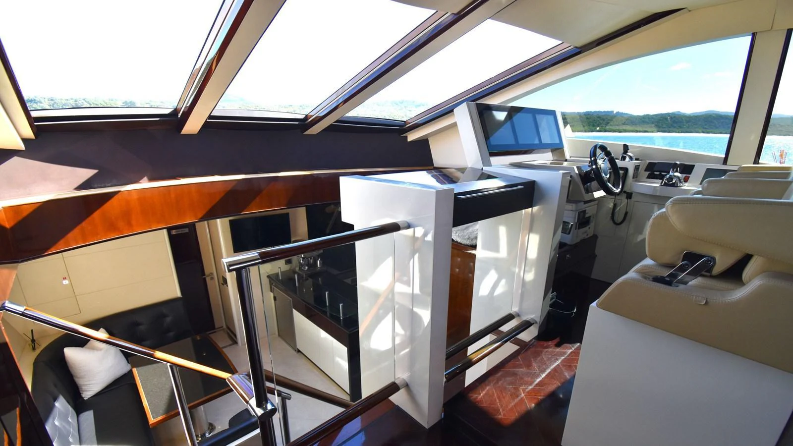 The helm area features a sleek, modern design with ample natural light from overhead windows. aboard LA MAR Yacht for Sale