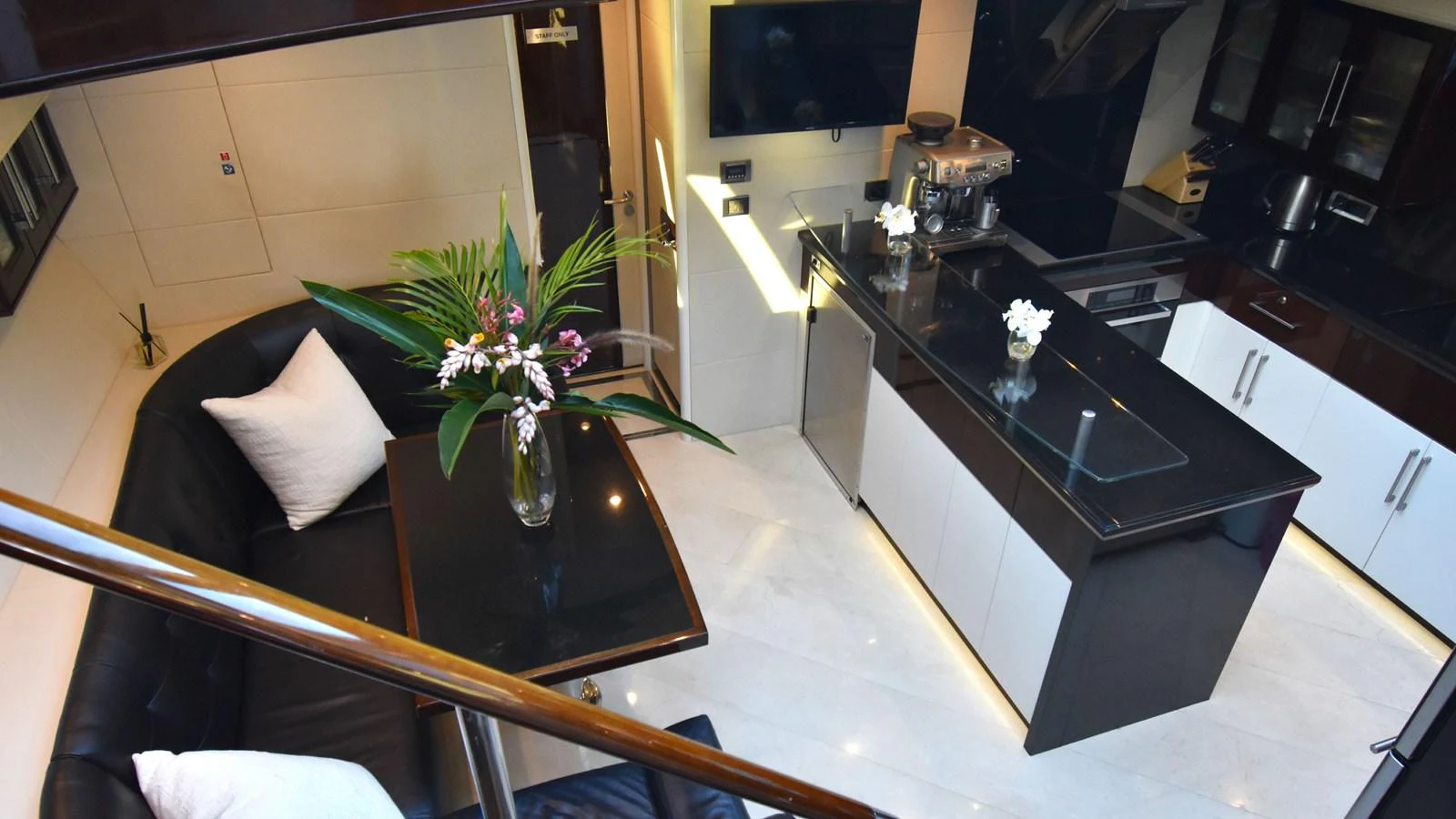 The yacht's galley features modern appliances and a stylish dining area with elegant decor. aboard LA MAR Yacht for Sale