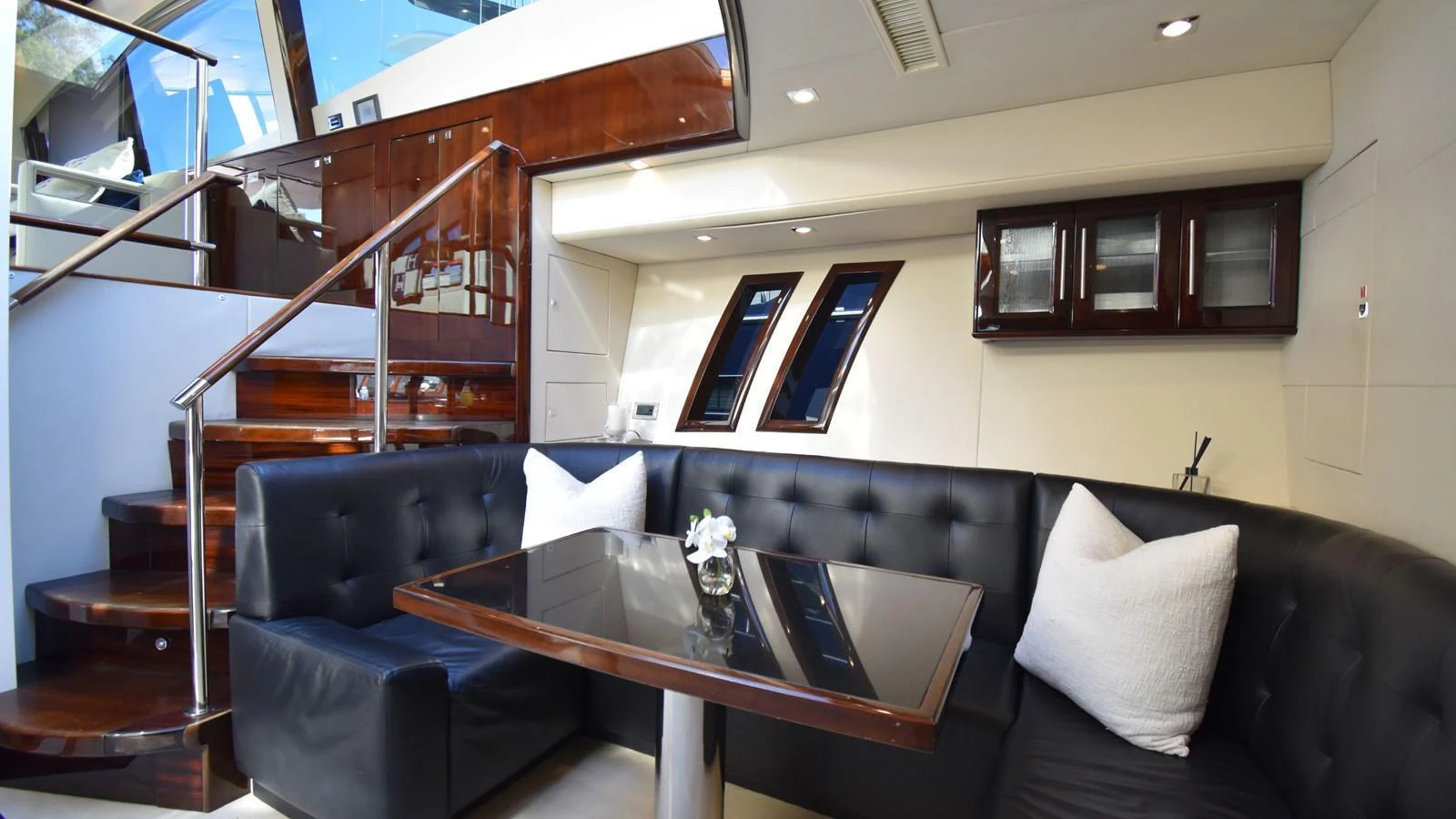 The salon features a cozy seating area with a polished wooden table and plush cushions, perfect for relaxation. aboard LA MAR Yacht for Sale