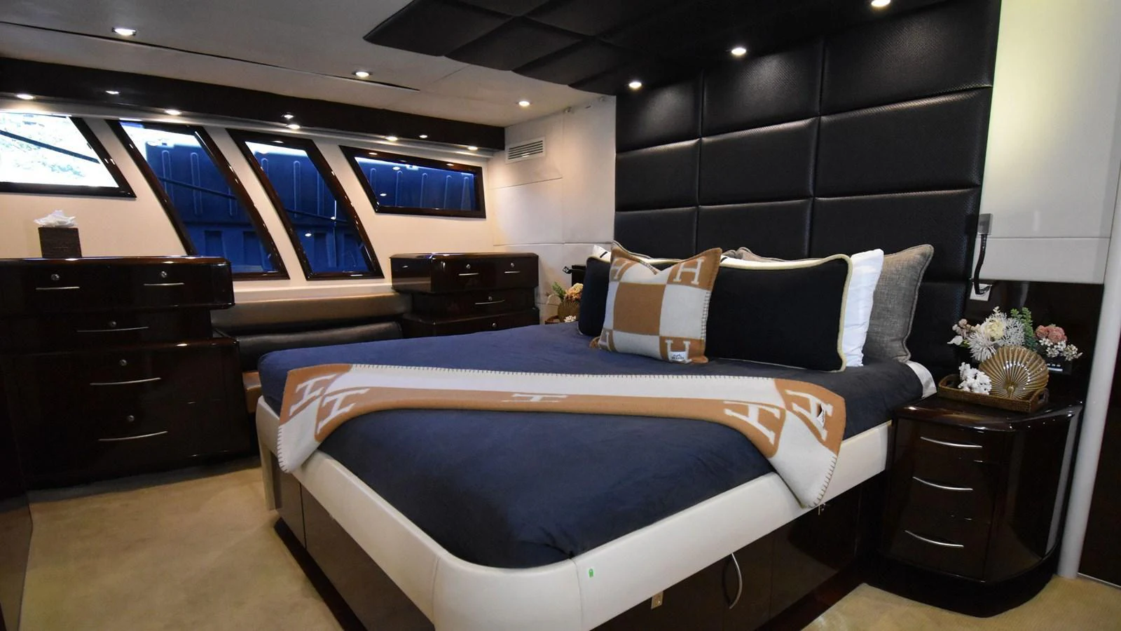 The master stateroom features a luxurious bed with elegant bedding and ample storage space. aboard LA MAR Yacht for Sale