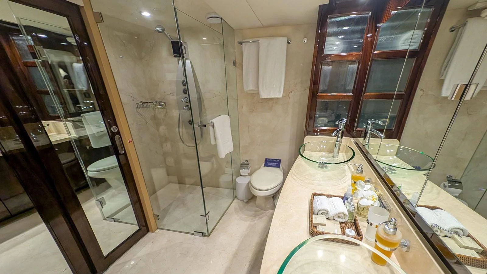 The yacht's bathroom features a spacious layout with elegant fixtures and a glass-enclosed shower. aboard LA MAR Yacht for Sale