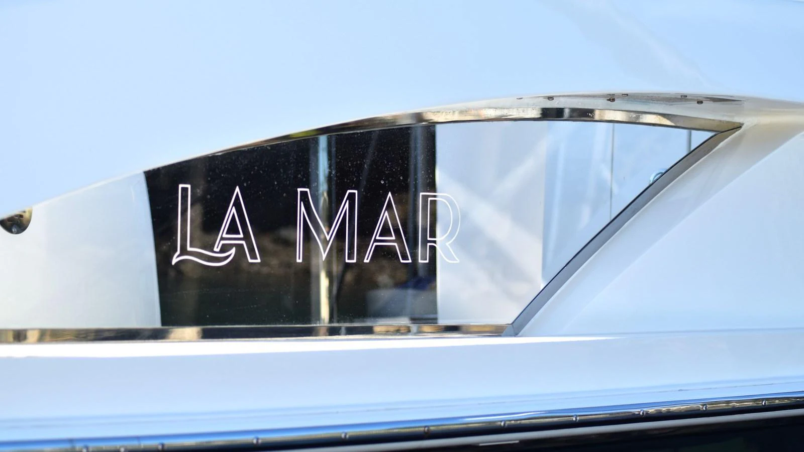 A close-up view of a yacht's nameplate with the name 'La Mar' elegantly displayed. aboard LA MAR Yacht for Sale